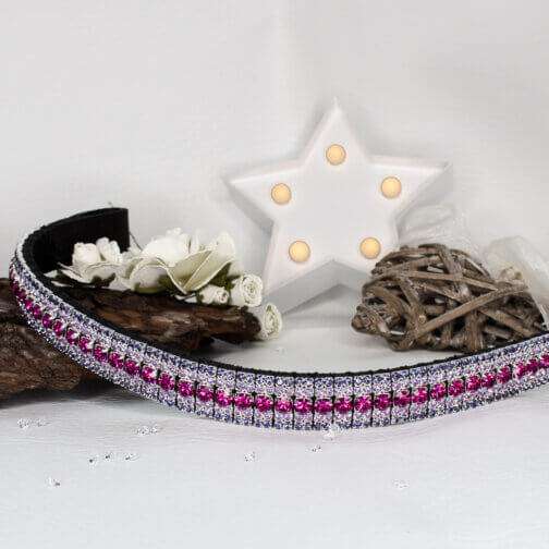 Purple and pink browband with a white star light and wooden ornaments with white flowers on a off-white backdrop