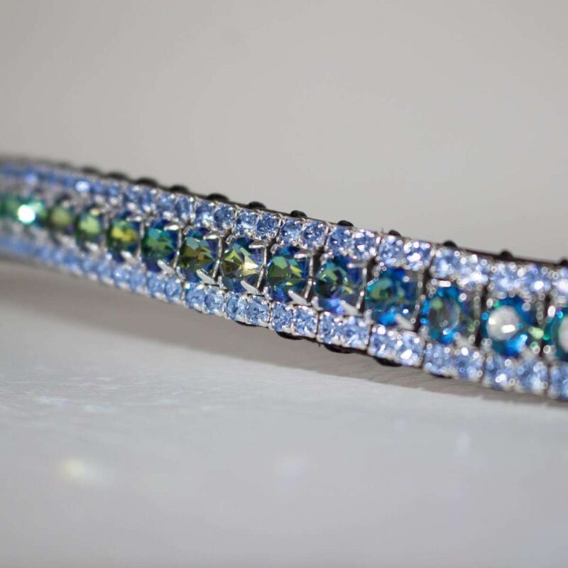 Close up of a Colour changing Bermuda Blue and Light Sapphire Browband on a white background