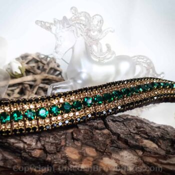 Luxurious horse browband with sparkling emerald green crystals complemented by gold settings and elegant black detailing