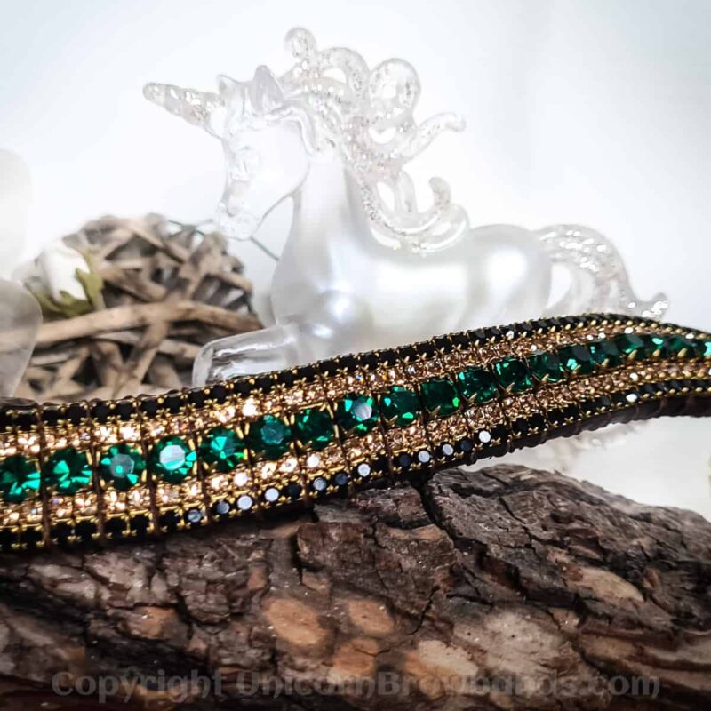 Luxurious horse browband with sparkling emerald green crystals complemented by gold settings and elegant black detailing